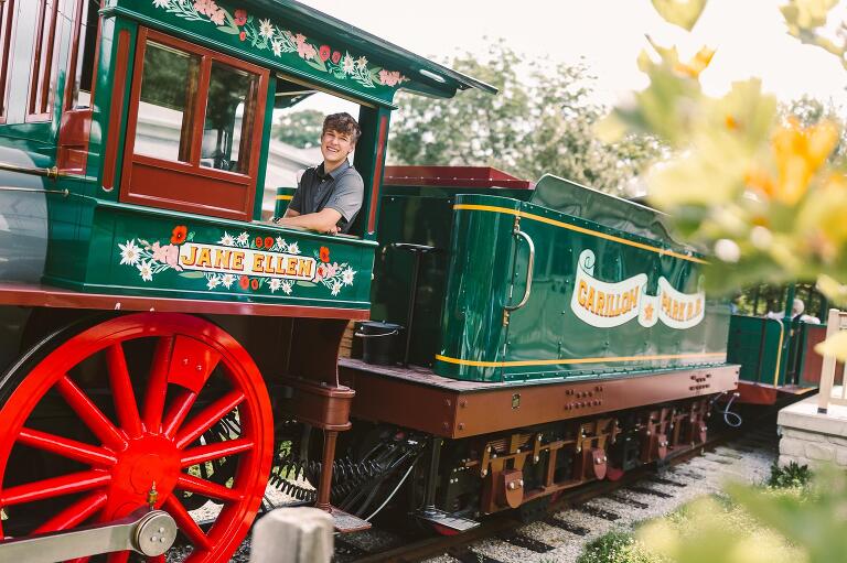Senior guy looking out the window of a historic train at Carillon Historical Park.